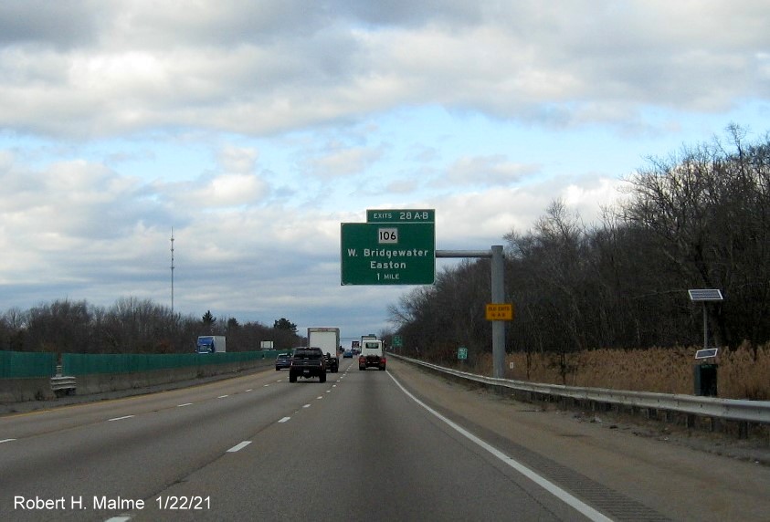 Image of 1-Mile advance overhead sign for MA 106 exits with new milepost based exit numbers and yellow Old Exits 16 B-A sign on support post on MA 24 North in West Bridgewater, January 2021