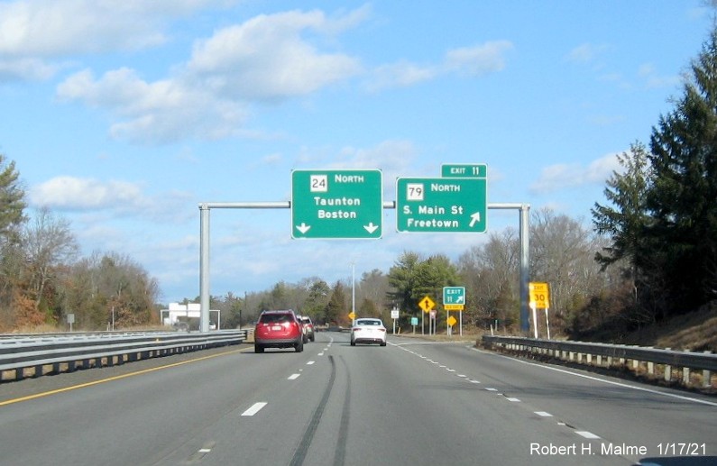 Image of overhead ramp signage at MA 79 North exit with new milepost based exit number and gore sign with yellow Old Exit 9 sign below on MA 24 North in Freetown, January 2021