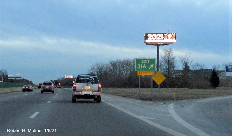 Image of gore sign for MA 123 East exit with new milepost based exit number 
                                      and yellow old exit number sign below on MA 24 South in Brockton, January 2021