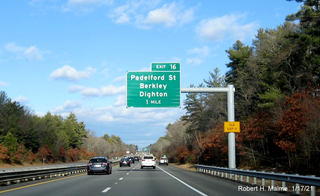 Image of 1-mile advance overhead sign for Padelford Street exit with new milepost based exit number and yellow Old Exit 11 sign on support post on MA 24 North in Berkley, January 2021