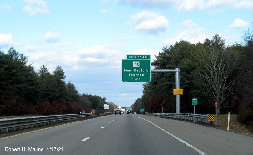Image of 1-Mile advance overhead sign for MA 140 exits with new milepost based exit numbers and yellow Old Exits 12 B-A sign on support post on MA 24 North in Taunton, January 2021