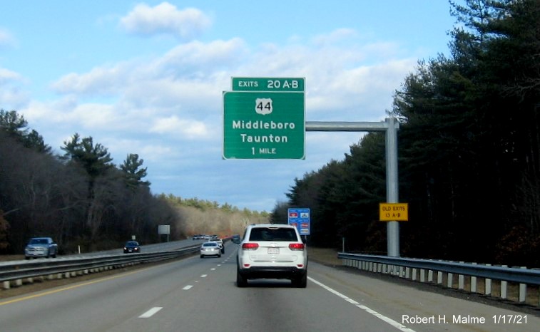 Image of 1-Mile advance overhead sign for US 44 exits with new milepost based exit number and yellow Old Exits 13 B-A sign on support post on MA 24 North in Taunton, January 2021
