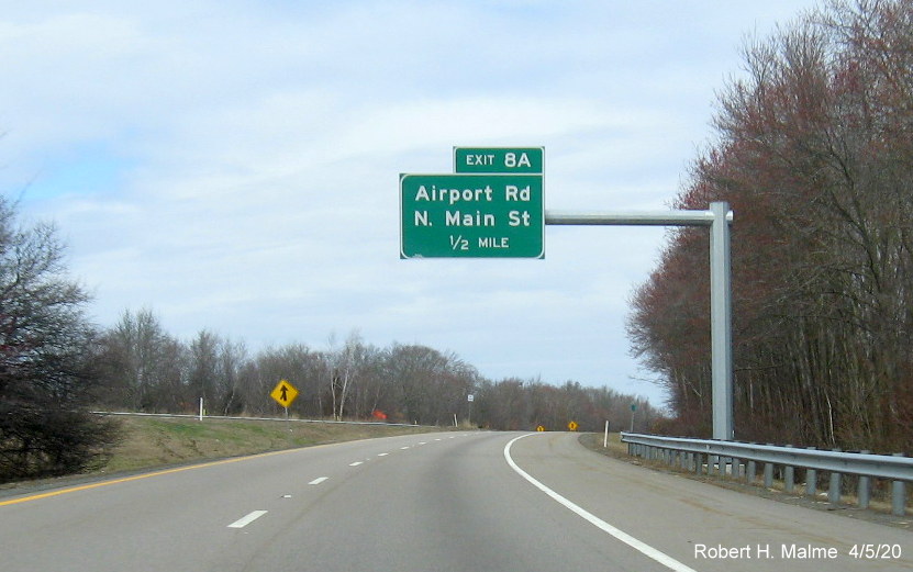 Image of recently placed 1/2 mile advance overhead sign for the Airport Road/North Main Street exit on MA 24 North in Fall River, taken in April 2020