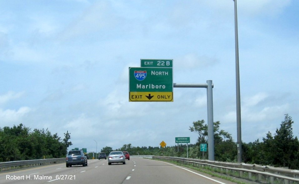 Image of 1/4 mile advance exit only tab overhead sign for I-495 North exit with new milepost based exit number on MA 24 North in Raynham, June 2021