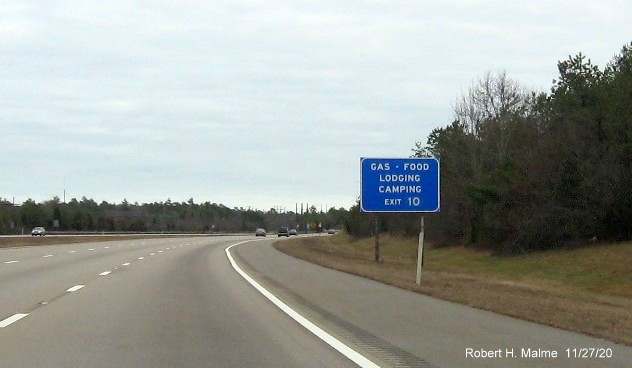Image of blue old fashioned services sign (without logos) with new milepost based exit number on MA 25 East in Bourne, November 2020