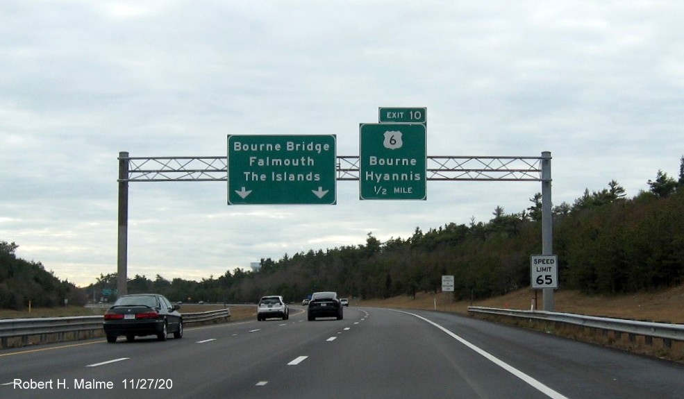 Image of 1/2 mile advance overhead sign for US 6 exit with new milepost based exit number on MA 25 East in Bourne, November 2020