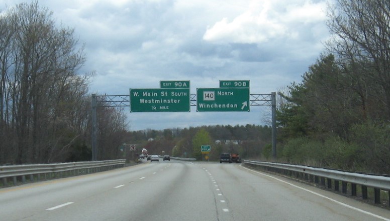 Image of overhead signage at ramp for MA 140 North exit with new milepost based exit number on MA 2 West in Westminster, May 2021