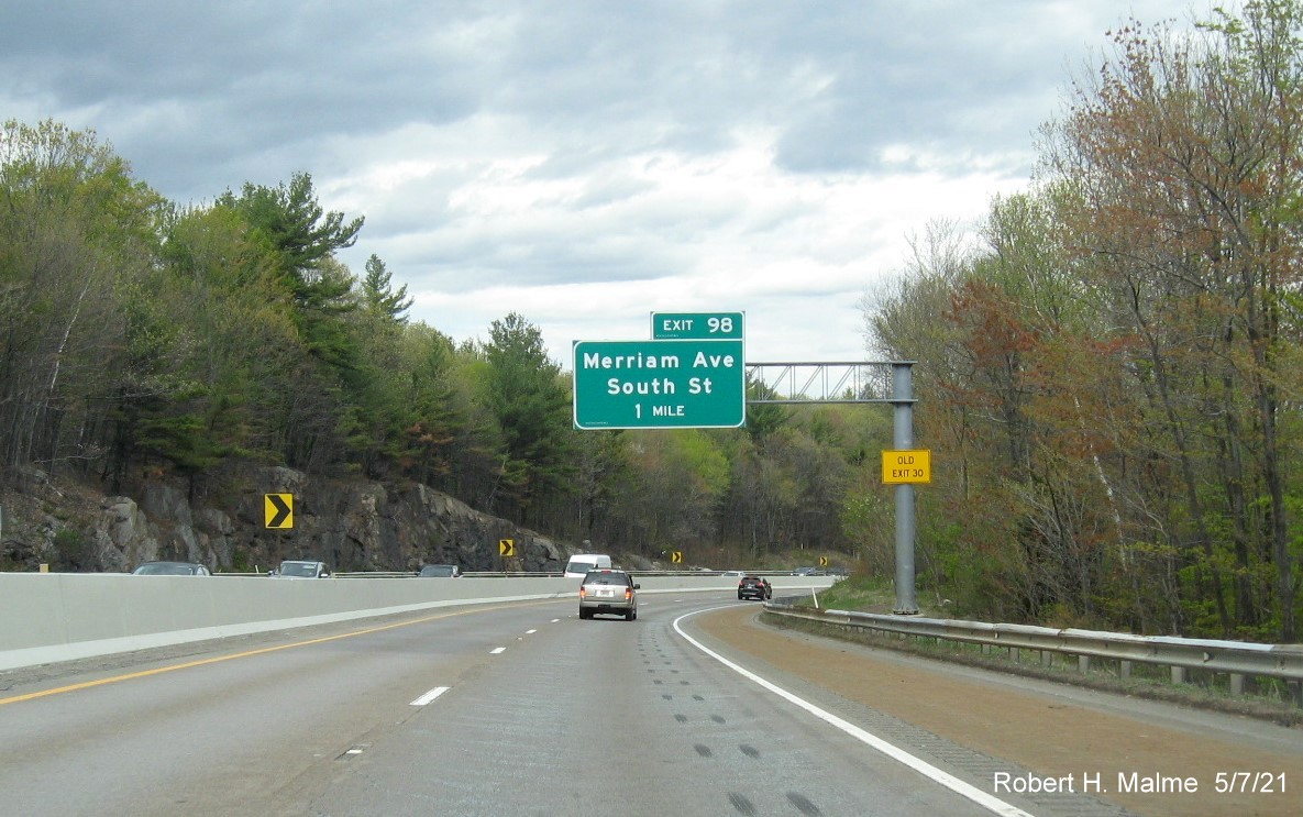 Image of 1 Mile advance overhead sign for Merriam Ave/South St exit with new milepost based exit number and yellow Old Exit 30 advisory sign on support on MA 2 East in Leominster, May 2021