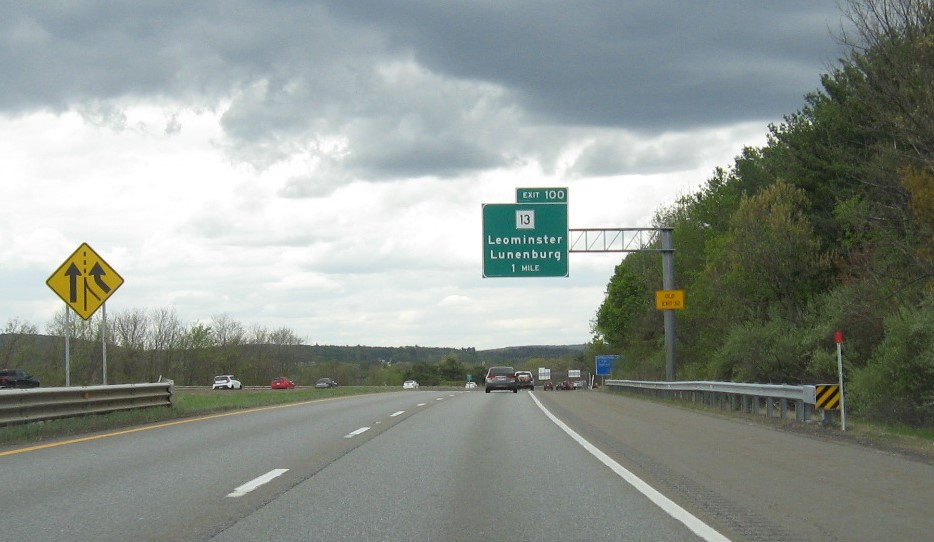 Image of 1 mile advance overhead sign for MA 13 exit with new milepost based exit number and yellow Old Exit 32 advisory sign on support on MA 2 West in Leominster, May 2021