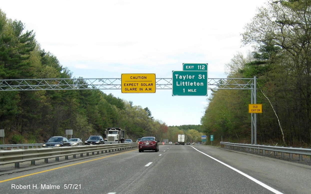 Image of 1 mile advance sign for Taylor Street exit with new milepost based exit number and yellow Old Exit 39 advisory sign on right support on MA 2 East in Littleton, May 2021