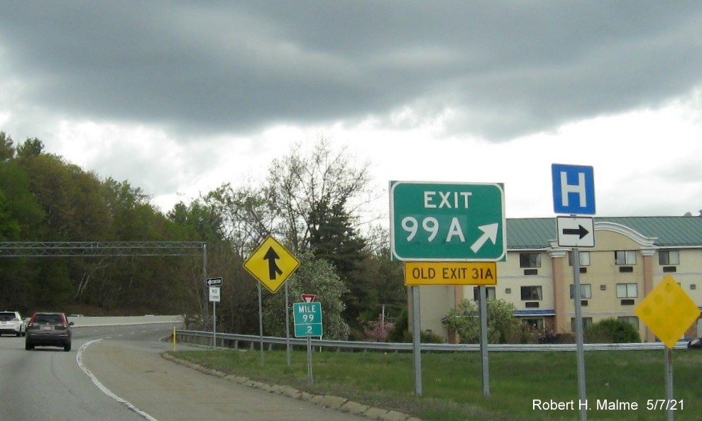 Image of gore sign for MA 12 North exit with new milepost based exit number and yellow Old Exit 31A sign attached below on MA 2 West in Leominster, May 2021