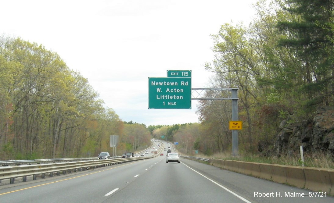 Image of 1 Mile advance overhead sign for Newtown Road exit with new milepost based exit number and yellow 
                                       Old Exit 41 advisory sign on support on MA 2 East in Acton, May 2021