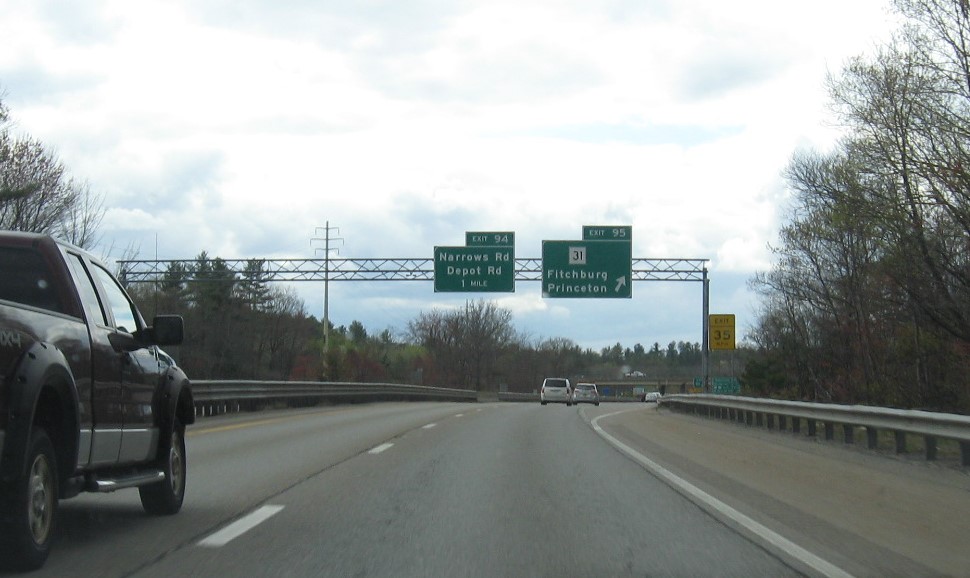 Image of overhead signage at ramp for MA 31 exit with new milepost based exit number on MA 2 West in Fitchburg, May 2021