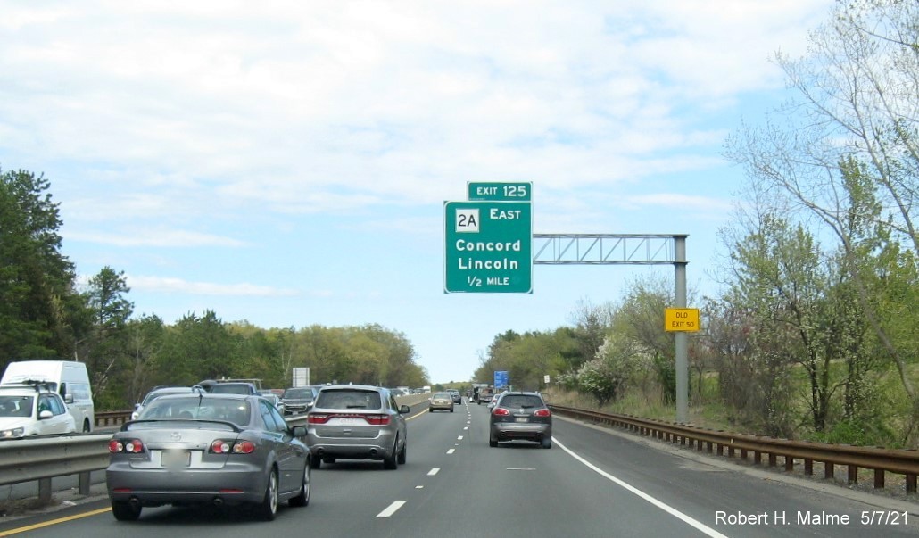 Image of 1/2 Mile advance sign for MA 2A East exit with new milepost based exit number and yellow Old Exit 50 advisory sign on support on MA 2/2A East in Concord, by Paul Schlichtman, April 2021