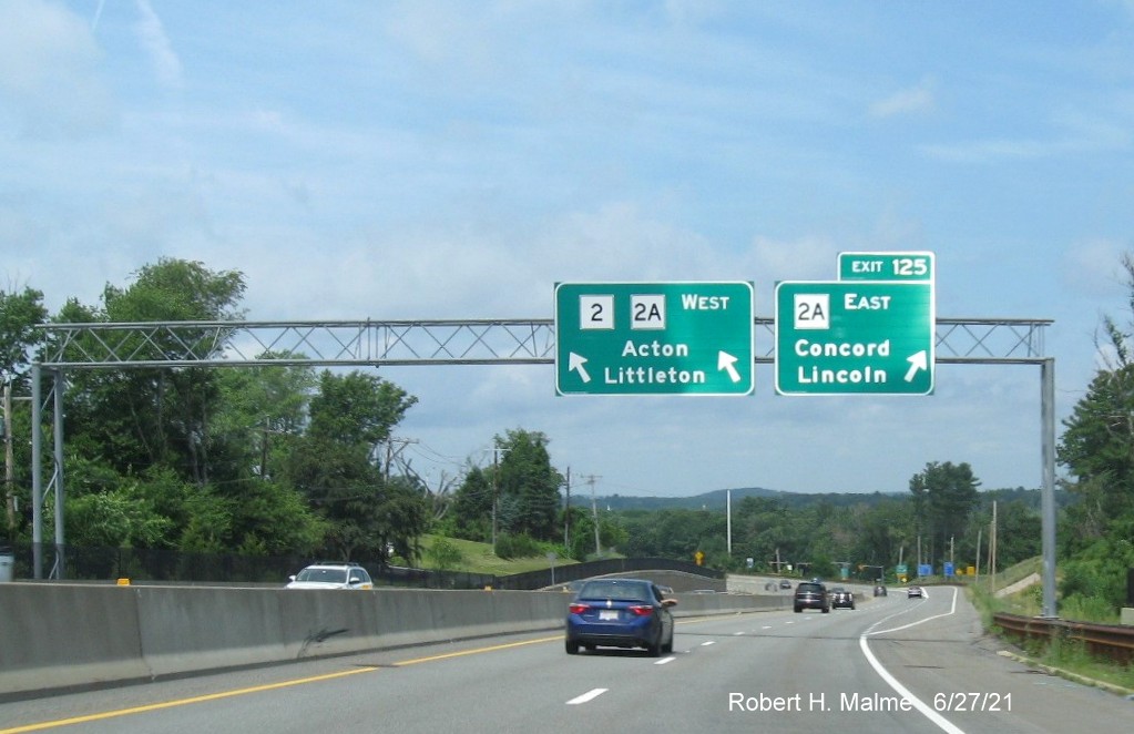 Image of overhead signs at ramp for MA 2A East exit with new milepost based exit number on MA 2 West in Concord, June 2021