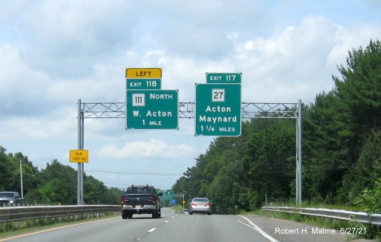 Image of overhead advance signs for MA 111 North and MA 27 exits with new milepost based exit numbers and yellow Old Exit 43 advisory sign on left support on MA 2 West in Acton, June 2021