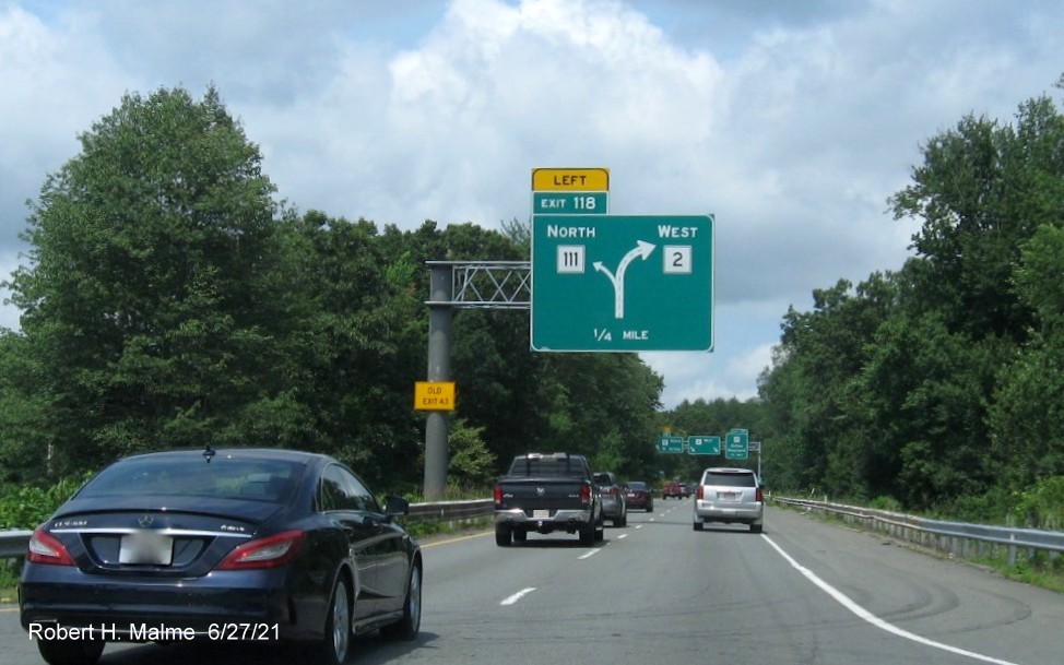 Image of 1/4 mile diagrammatic overhead signage for MA 111 North exit with new milepost based exit number and yellow Old Exit 43 advisory sign on support on MA 2 West in Acton, June 2021