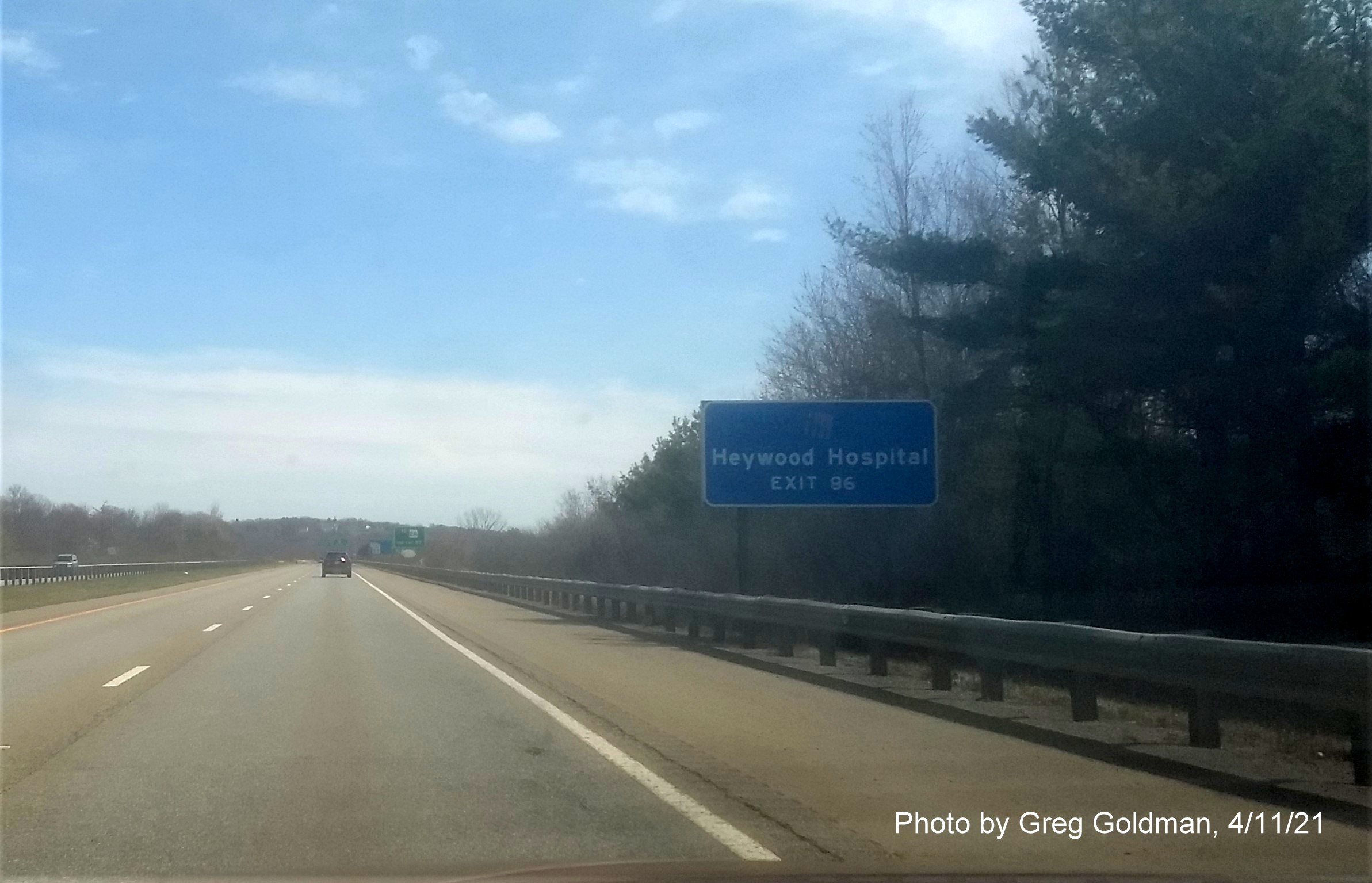 Image of blue hospital sign for MA 68 Exit with new milepost based exit number on MA 2 East in Gardner, by Greg Goldman, April 2021