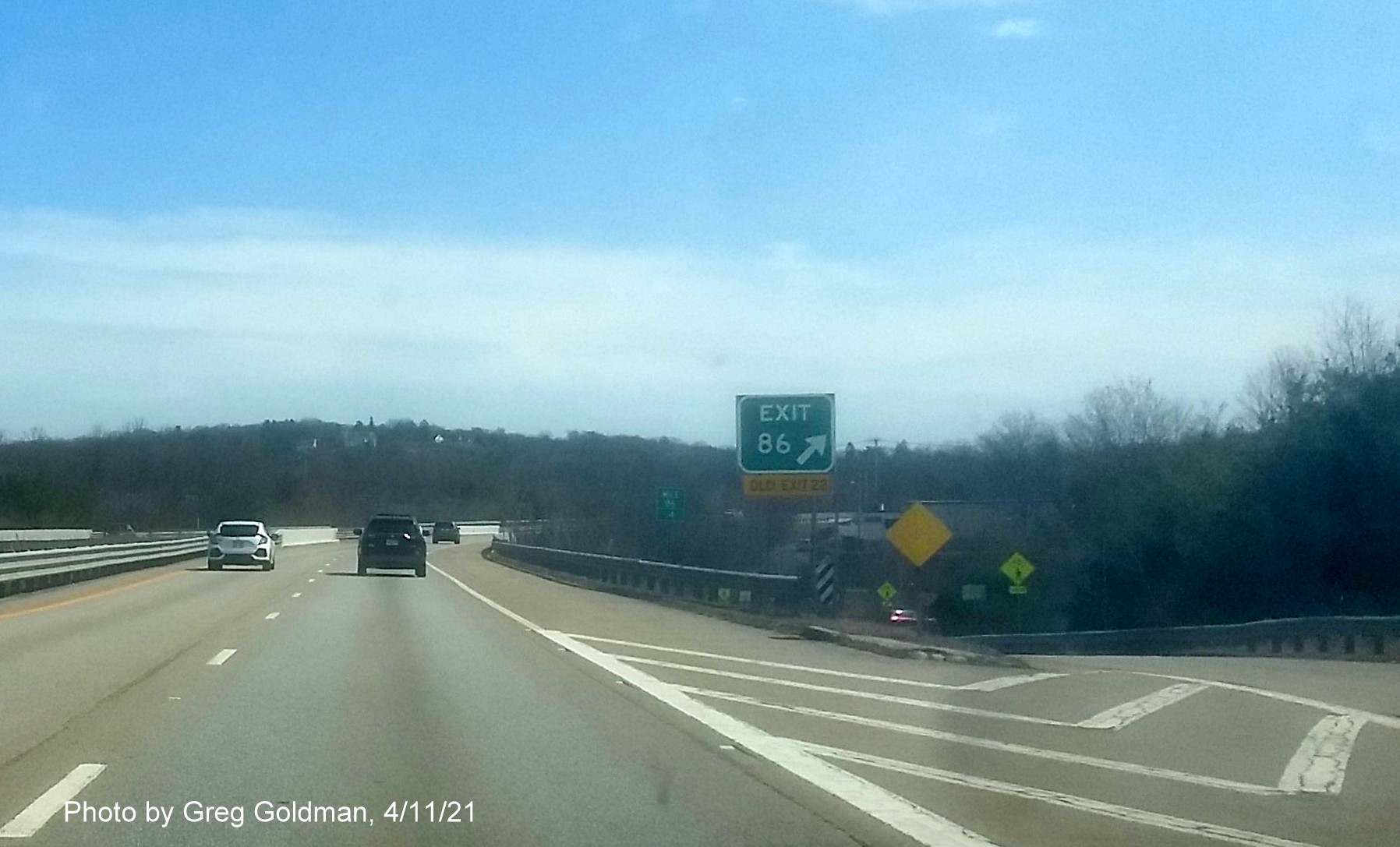 Image of gore sign for MA 68 Exit with new milepost based exit number and yellow Old Exit 24 advisory sign attached below on MA 2 East in Gardner, by Greg Goldman, April 2021