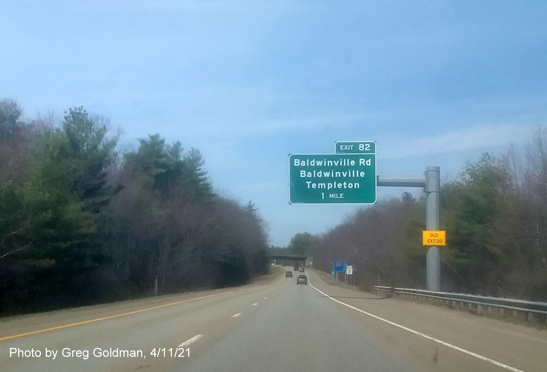 Image of 1 Mile advance sign for Baldwinville Road exit with new milepost based exit number and yellow Old Exit 20 advisory sign on support on MA 2 West in Templeton, by Greg Goldman, April 2021