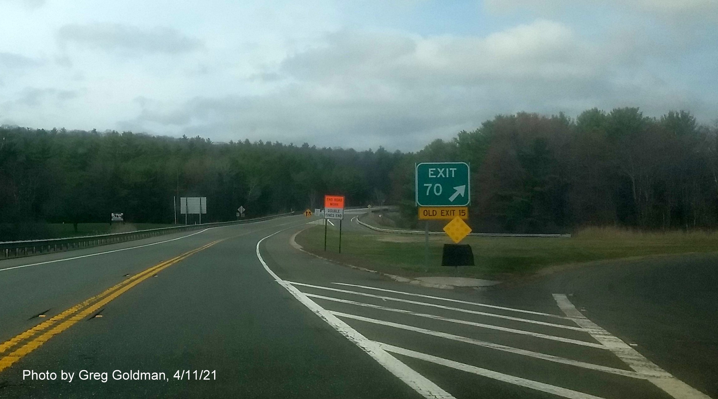 Image of gore sign for MA 122 exit with new milepost based exit number and yellow Old Exit 15 sign attached below on MA 2 West in Orange, by Greg Goldman, April 2021