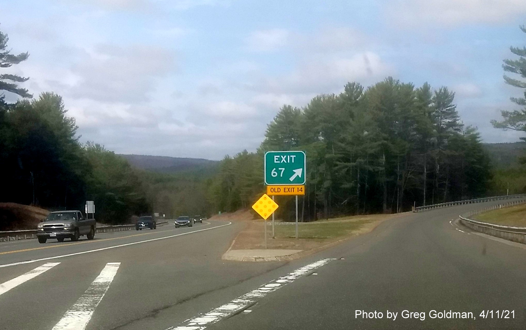 Image of ramp sign for West River Street exit with new milepost based exit number and yellow Old Exit 14 sign attached below on MA 2 West in Orange, by Greg Goldman, April 2021
