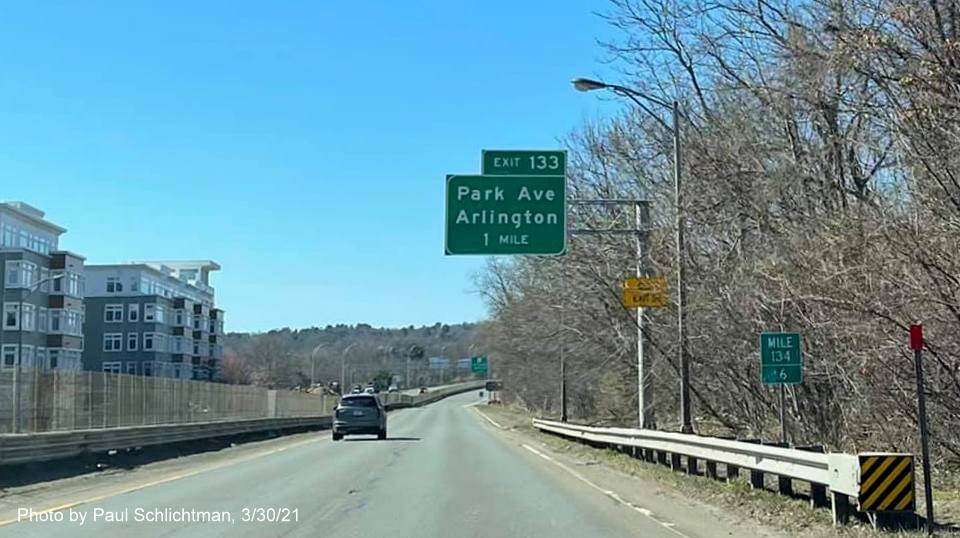 Image of 1 mile advance overhead sign for Park Avenue exit with new milepost based exit number and yellow Old Exit 58 sign on support on MA 2 West in Arlington, by Paul Schlichtman, March 2021