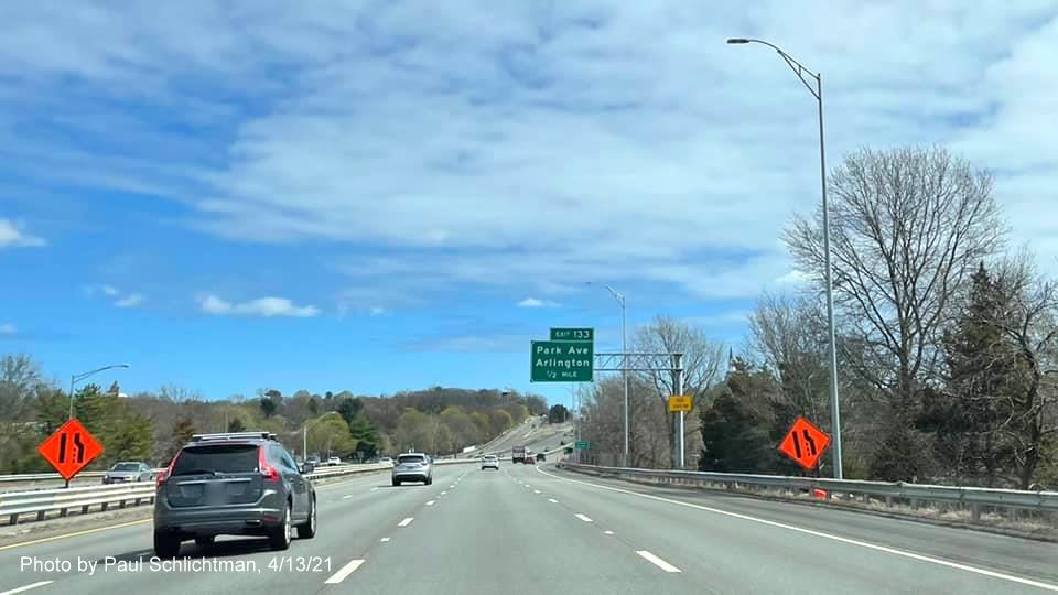 Image of 1/2 mile advance overhead sign for Park Avenue exit with new milepost based exit number and yellow Old Exit 58 sign on support on MA 2 East in Arlington, by Paul Schlichtman, April 2021