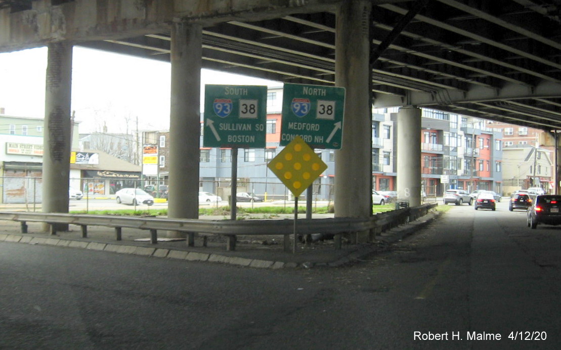Image of I-93/MA 38 guide signs pointing in both directions along MA 28 South in Somerville, taken in April 2020