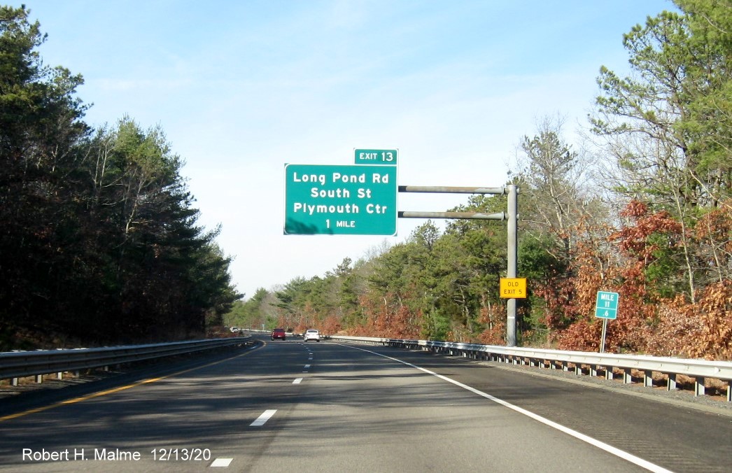 Image of 1 mile advance overhead sign for Long Pond Road exit with new milepost based exit number and yellow old exit number sign on support on MA 3 North in Plymouth, December 2020