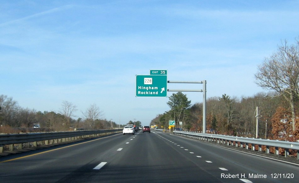 Image of overhead ramp sign for MA 228 exit with new milepost based exit number on MA 3 North in Rockland, December 2020