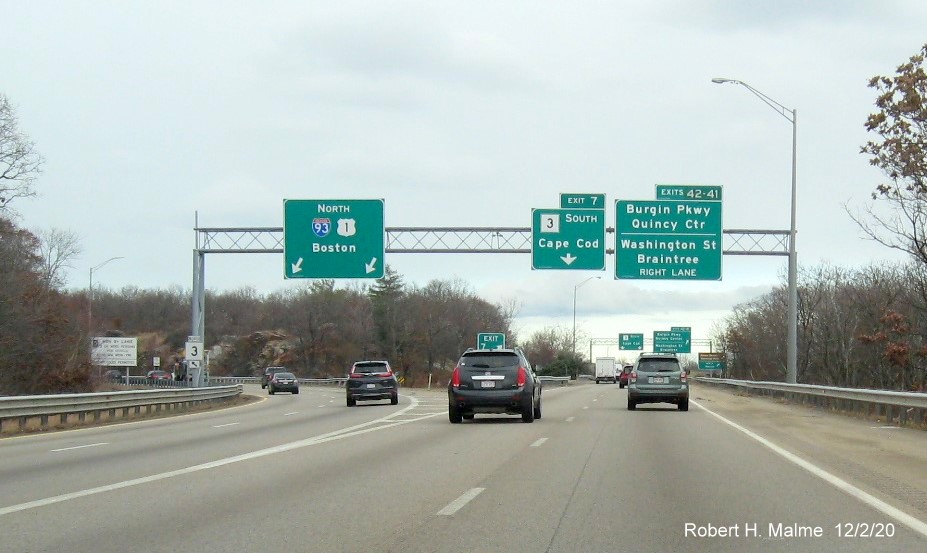 Image of overhead signs with 1/4 mile advance for Burgin Parkway/Washington Street exits with new milepost 
                                      exit numbers at MA 3 South exit ramp from I-93/US 1 in Braintree, December 2020
