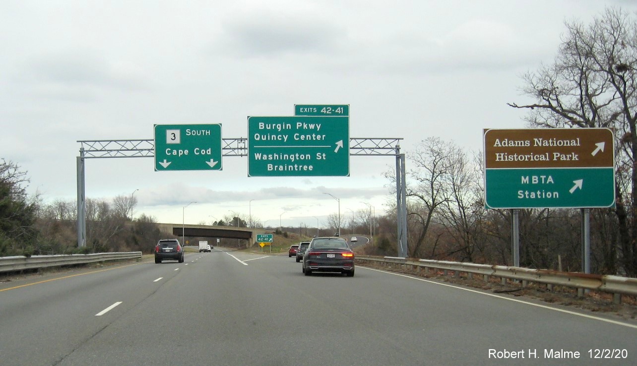 Image of overhead signs at ramp to Burgin Parkway/Washington Street exits with new milepost exit numbers on ramp from
                                      I-93/US 1 North to MA 3 South in Braintree, December 2020