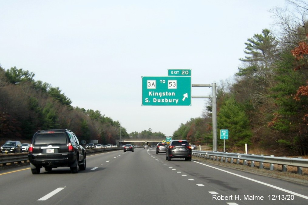 Image of overhead ramp sign for MA 3A exit with new milepost based exit number and gore sign with new number and yellow old exit number tab below on MA 3 North in Kingston, December 2020