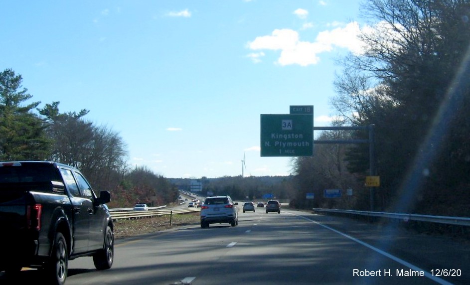 Image of the 1-Mile advance overhead sign for MA 3A exit with new milepost based exit number and yellow old exit number sign on support post on MA 3 South in Kingston, December 2020