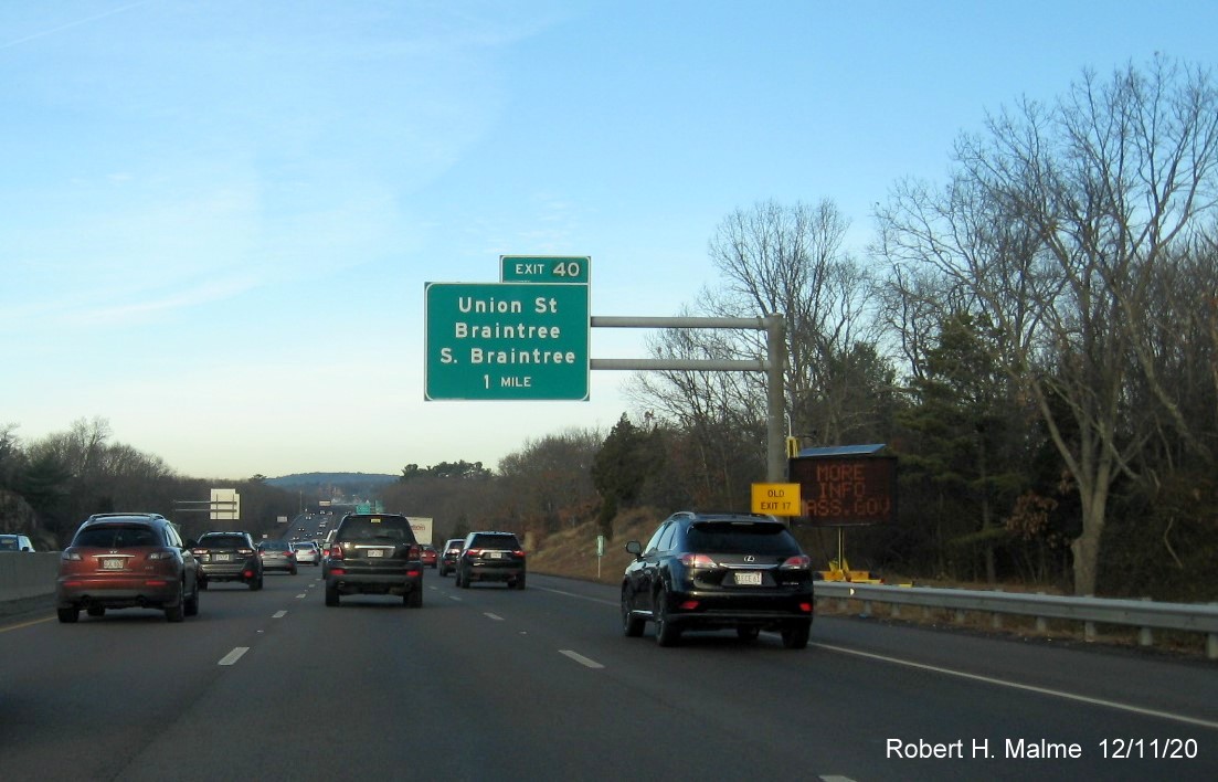 Image of 1-Mile advance overhead sign for Union Street exit with new milepost based exit number and yellow old exit number sign on support on MA 3 North in Braintree, December 2020