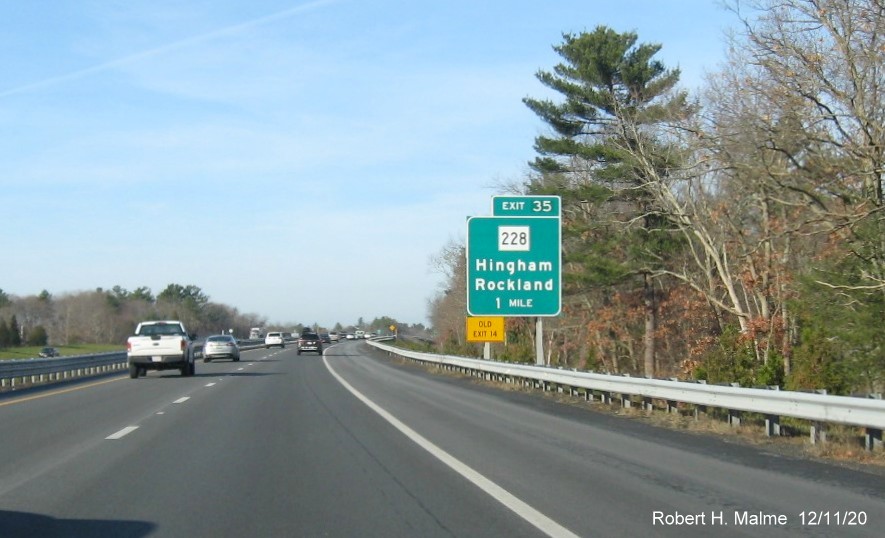 Image of 1-mile advance ground mounted sign for MA 228 exit with new milepost based exit number and yellow old exit number tab on left support on MA 3 North in Norwell, December 2020