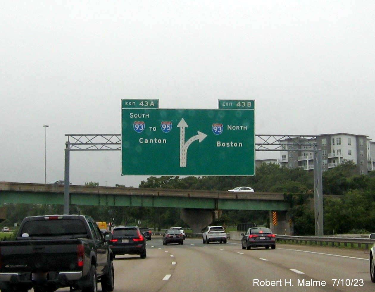  Image of 1/2 mile advance overhead diagrammatic sign for I-93 exits with yellow Old Exit tab removed from left exit tab on MA 3 North in Braintree, July 2023