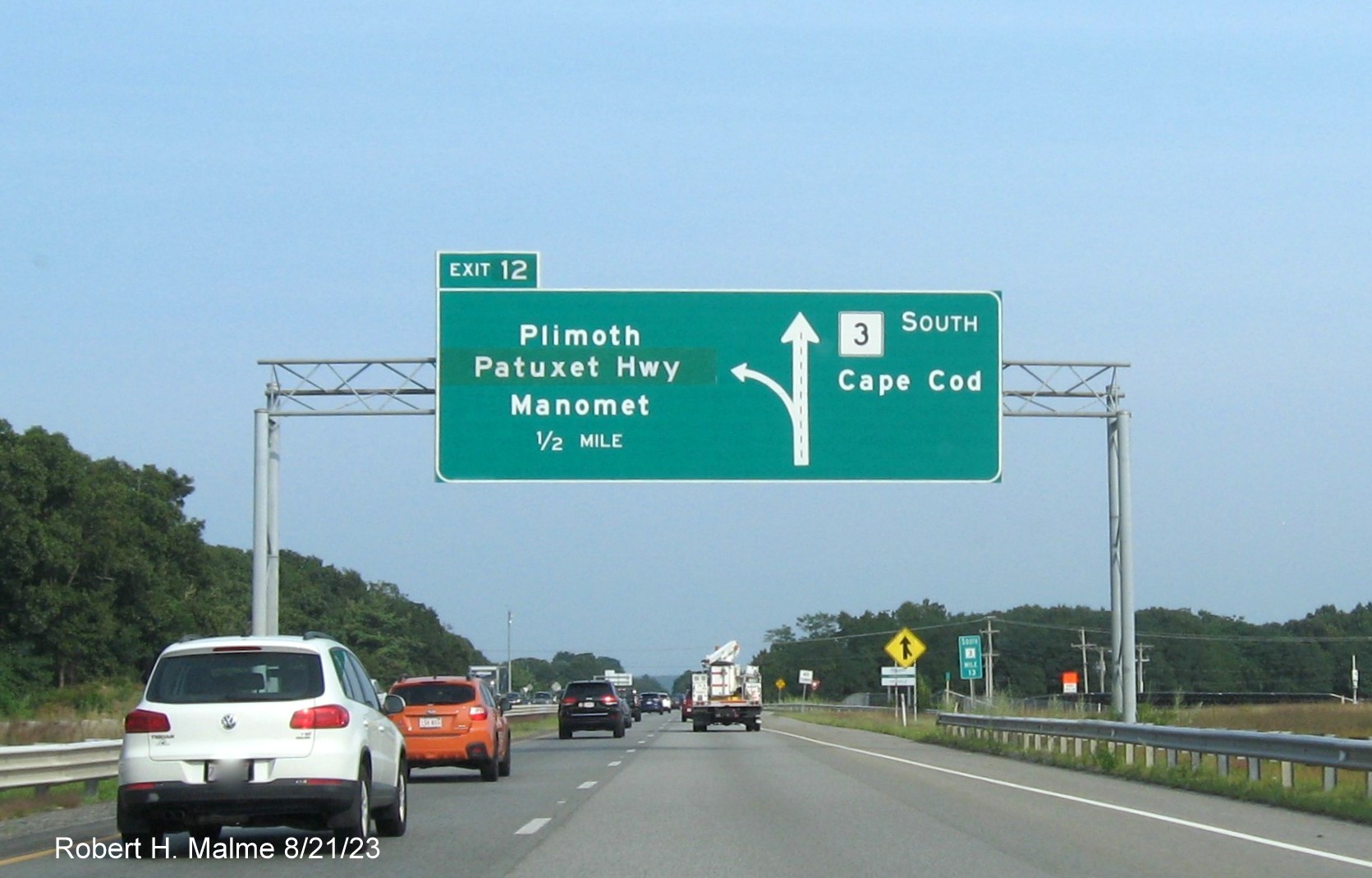 Image of 1/2 Mile advance overhead diagrammatic sign for Plimoth Patuxet (formerly Plimoth Plantation) Highway with yellow Left Exit panel removed from Exit 12 tab on MA 3 South in Plymouth, August 2023