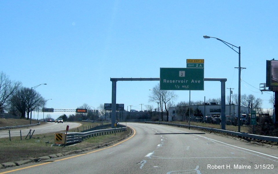 Image of overhead 1/2 mile advance sign for RI 2 exit on RI 10 South in Providence with new exit number and old exit number tab, taken in March 2020