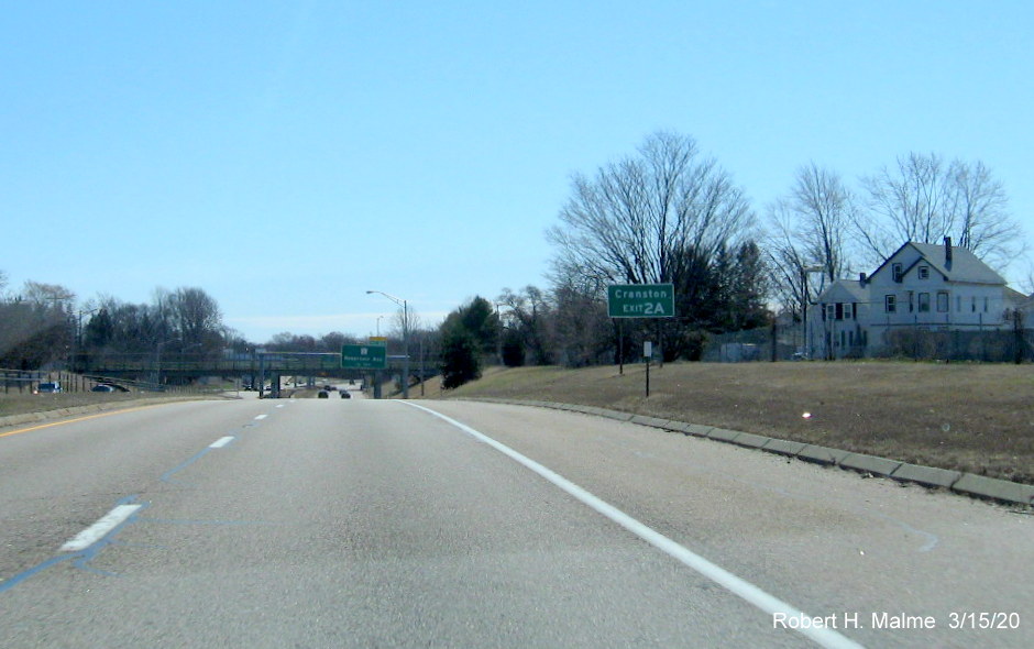 Image of ground mounted auxiliary sign updated with new exit number for RI 2 exit on RI 10 South in Providence, taken in March 2020