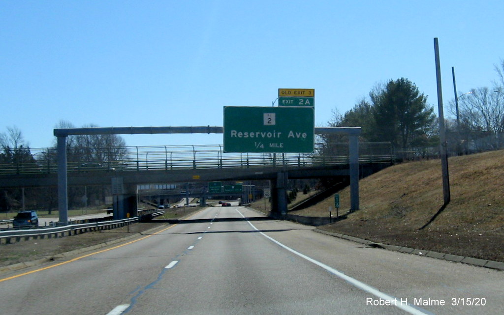 Image of overhead 1/4 mile advance sign for RI 2 exit on RI 10 South in Providence with new exit number and old exit number tab on top of sign, taken in March 2020