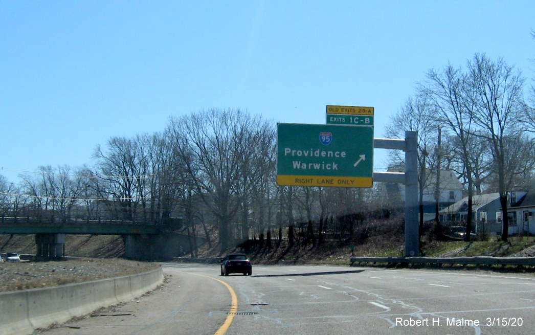 Image of overhead ramp sign for I-95 exits on RI 10 South in Providence with new exit numbers and old exit numbers tab, taken March 2020