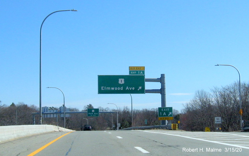 Image of overhead ramp sign for US 1 exit on RI 10 South with new exit number and old exit number tab, taken March 2020