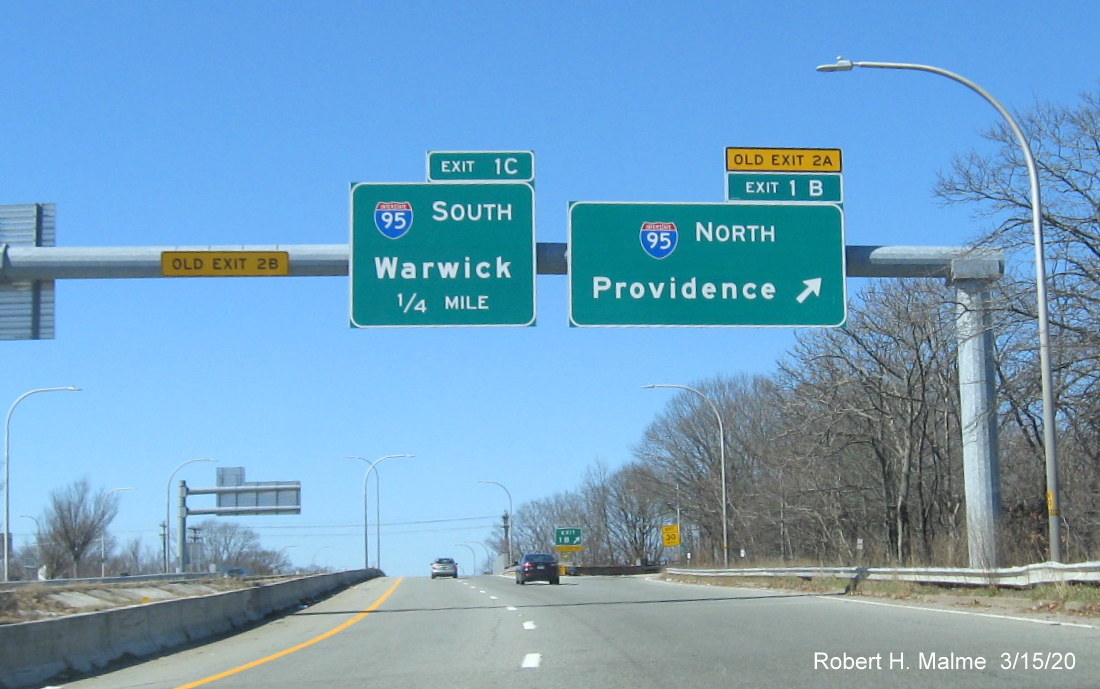 Image of overhead signs for I-95 exits on RI 10 North in Providence with new exit numbers and old exit number tabs, taken in March 2020