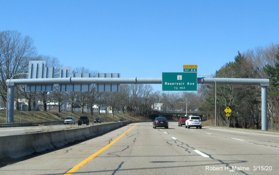 Image of overhead 1/2 mile advance sign for RI 2 exit on RI 10 North in Providence with new exit number and old exit number tab on top, taken in March 2020
