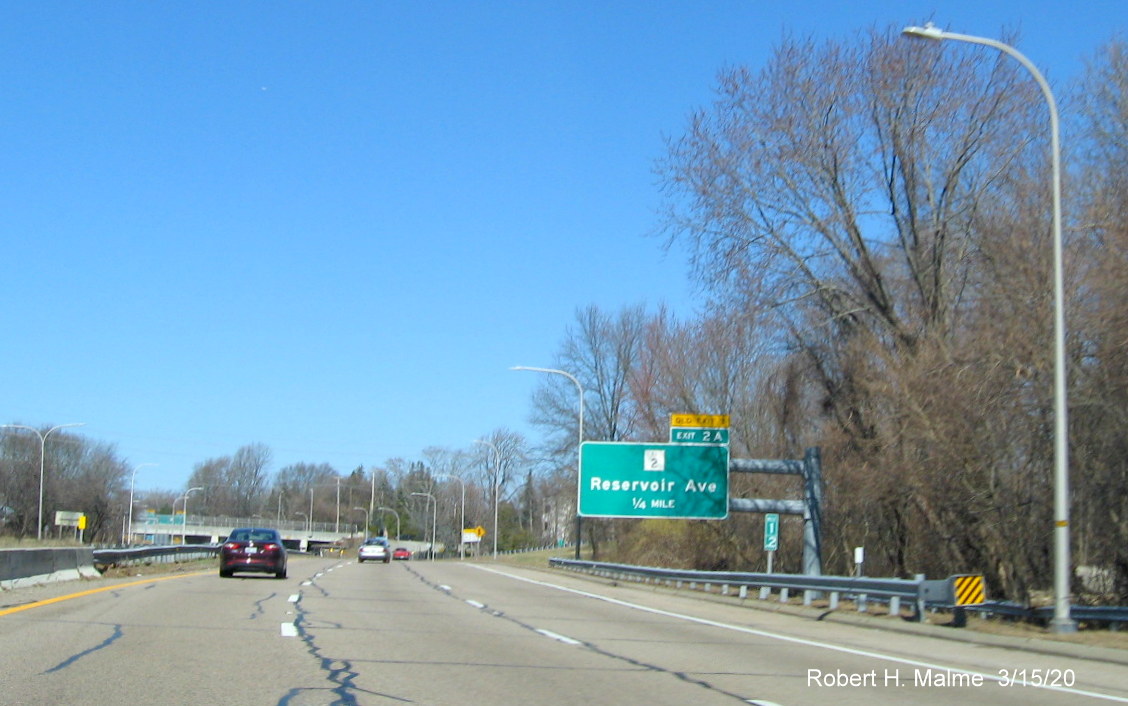 Image of cantilever 1/4 mile advance sign for RI 2 exit on RI 10 North in Providence with new exit number and old exit number tab, taken in March 2020