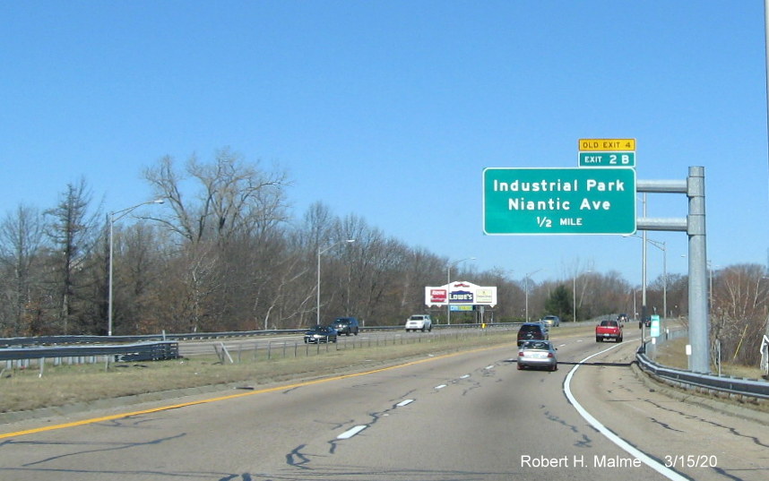 Image of overhead 1/4 mile advance sign for Industrial Park exit on RI 10 North in Providence, with new exit number and old exit number tab on top, taken in March 2020