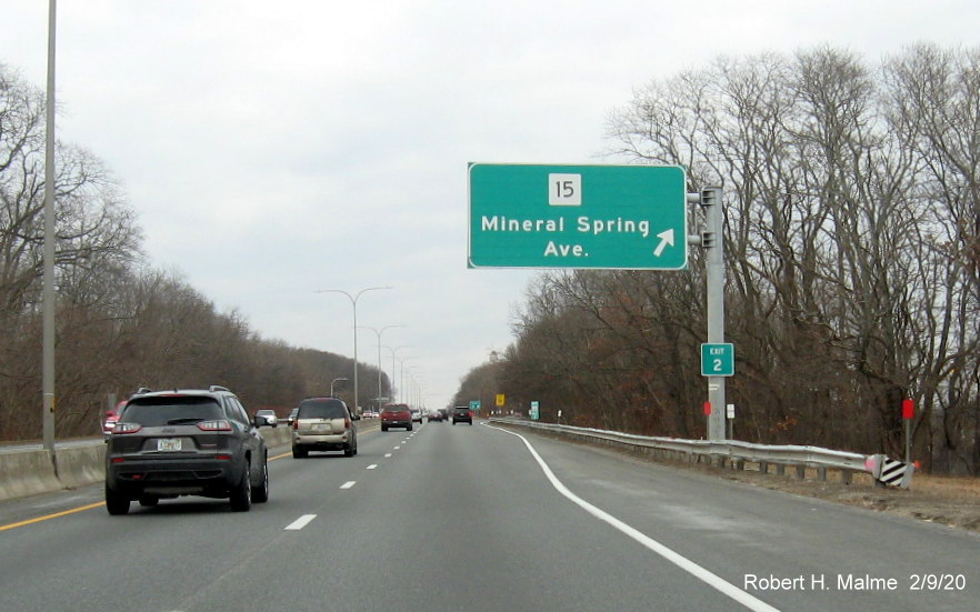 Image of Exit 2 sign placed on support post of RI 15 ramp sign on RI 146 North in North Providence