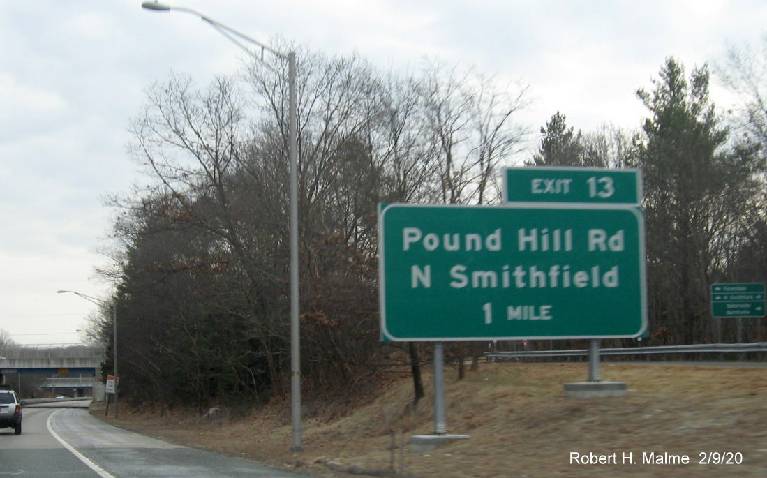 Image of ground mounted 1-Mile advance sign with new milepost based exit number for Pound Hill Road exit on RI 146 South in North Smithfield